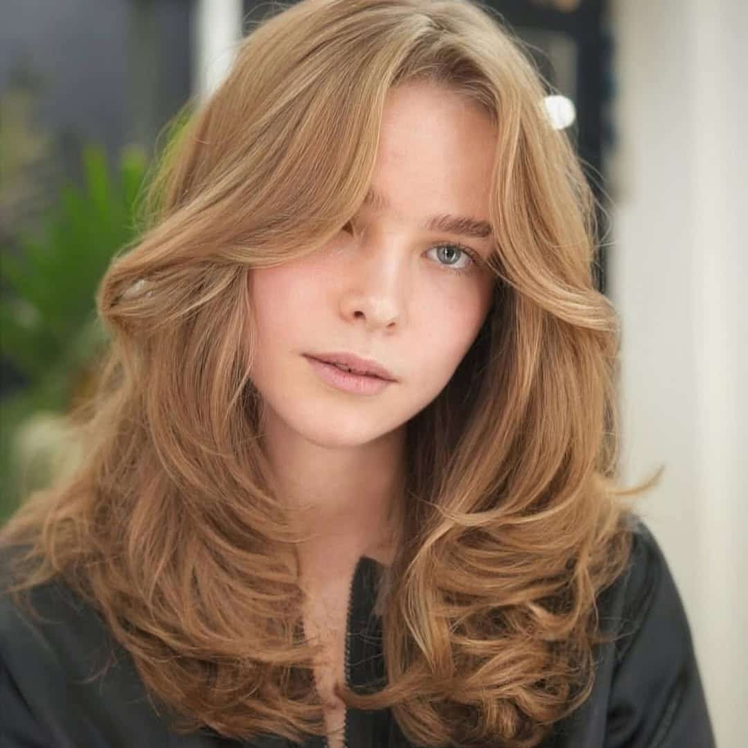 19. 70s-Inspired Long Layers with Soft Curtain Bangs