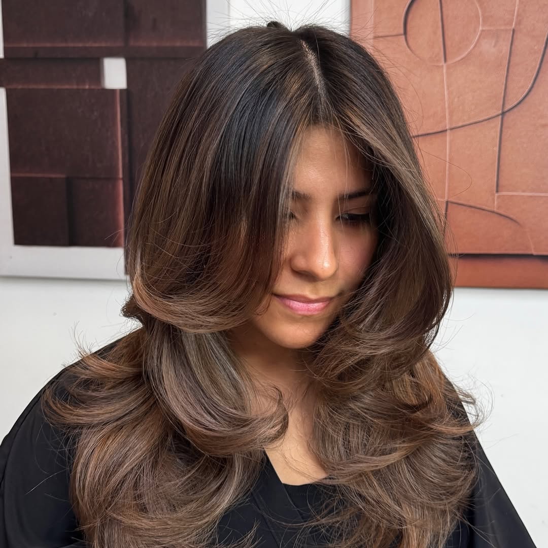 2. Bouncy Face-Framing Layers with Soft Curtain Bangs