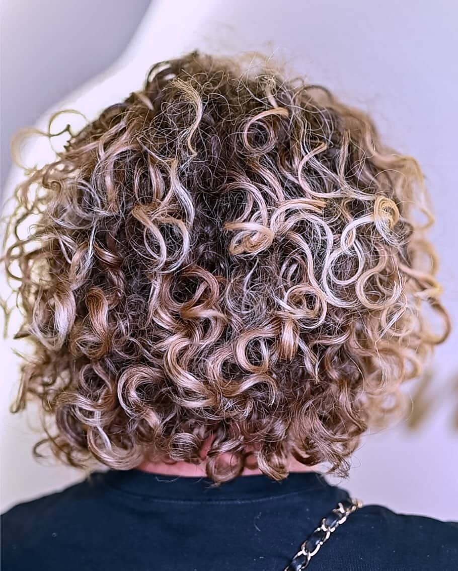 2. Curly Bob with Honey and Ash Highlights
