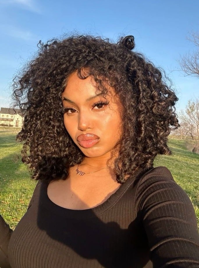 11. Curly Bob with Top Knot Accent