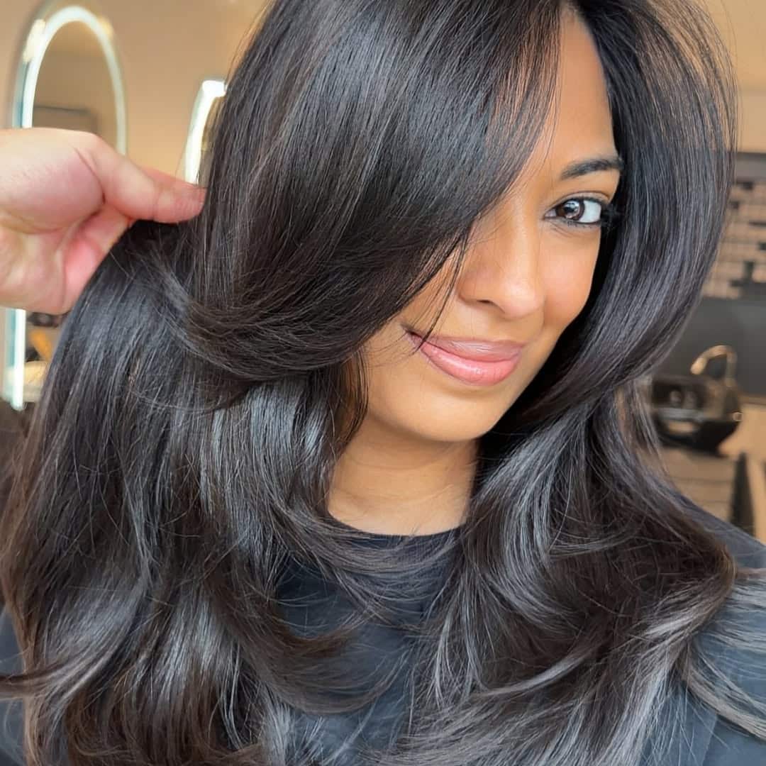 6. Face-Framing Swoopy Layers with Side Bangs