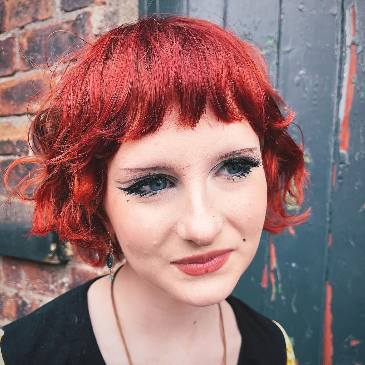 8. Fiery Red Curly Bob with Fringe