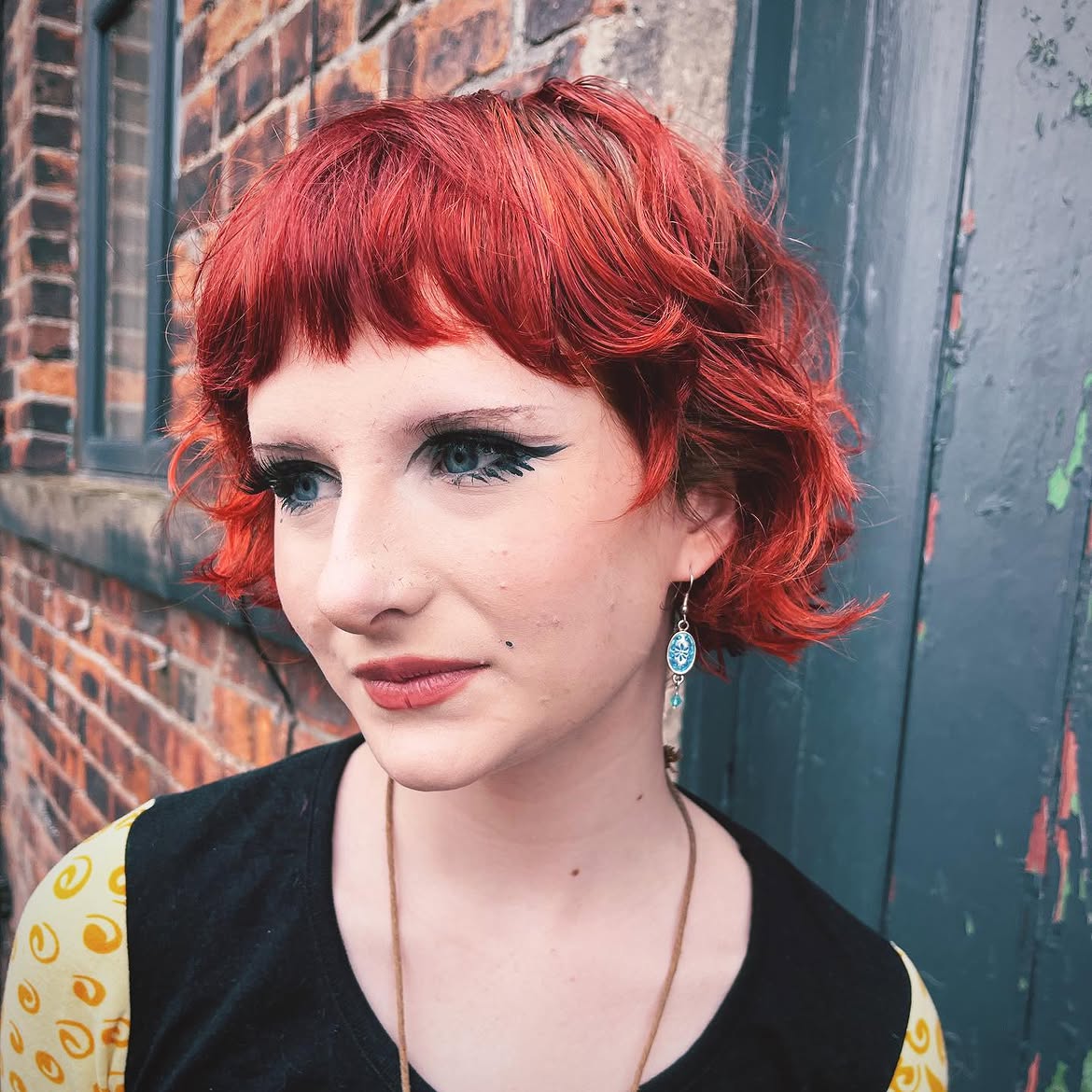 7. Firecracker Curly Bob with Micro Bangs