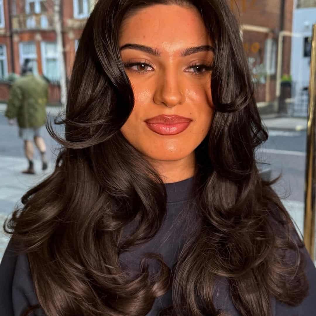 28. Glossy Face-Framing Layers with Long Curtain Bangs