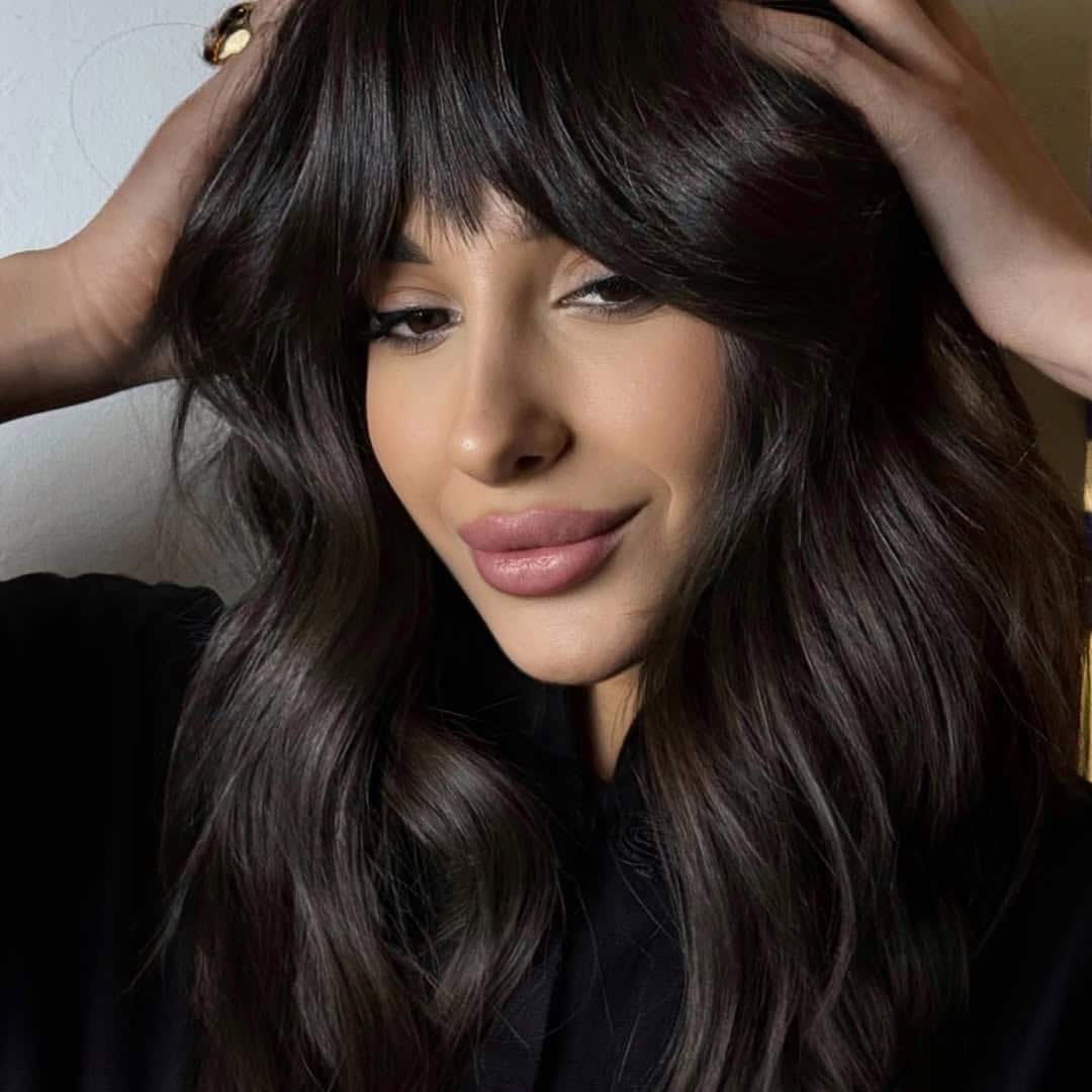 7. Glossy Waves with Full Curtain Bangs