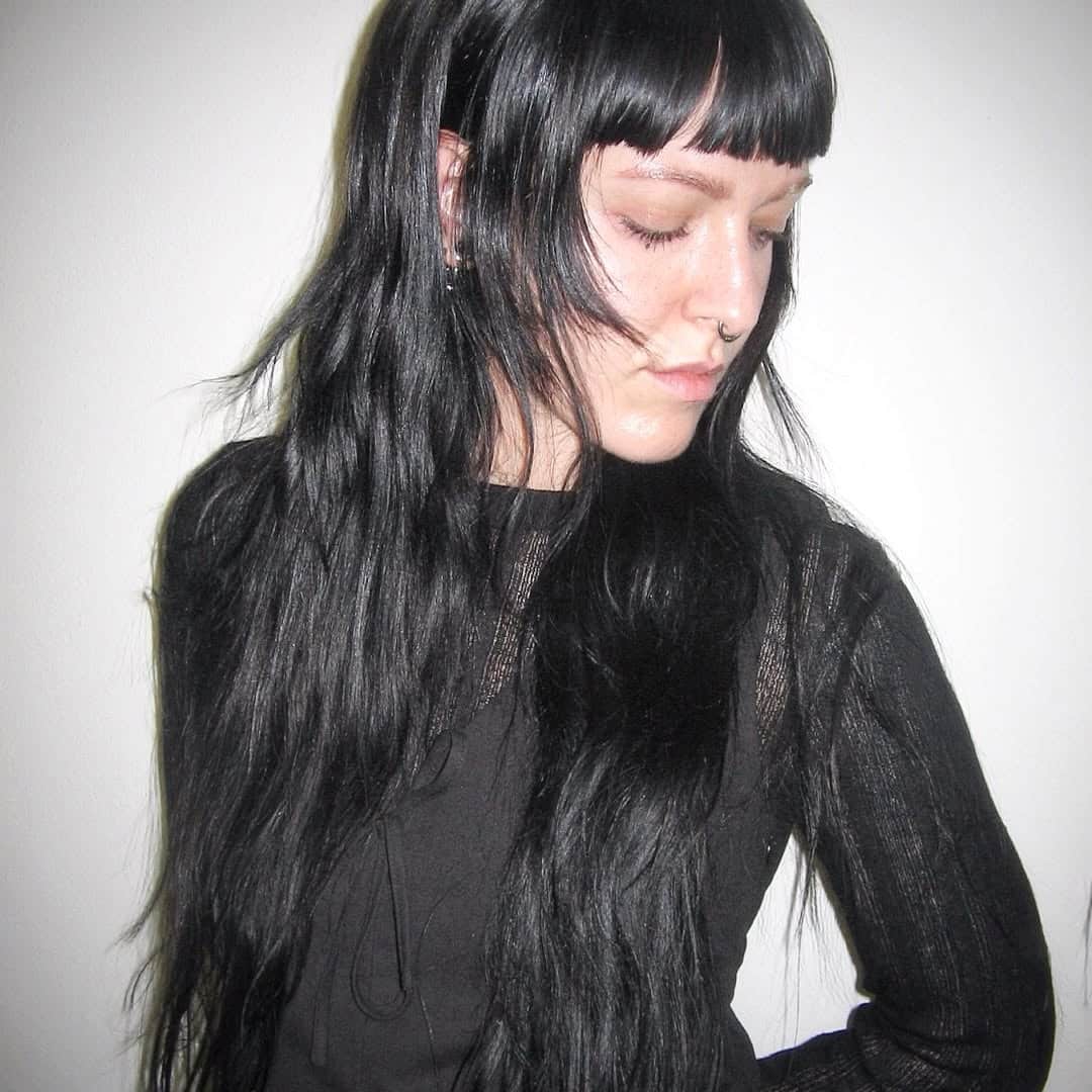 23. Jet Black Layers with Blunt Micro Bangs