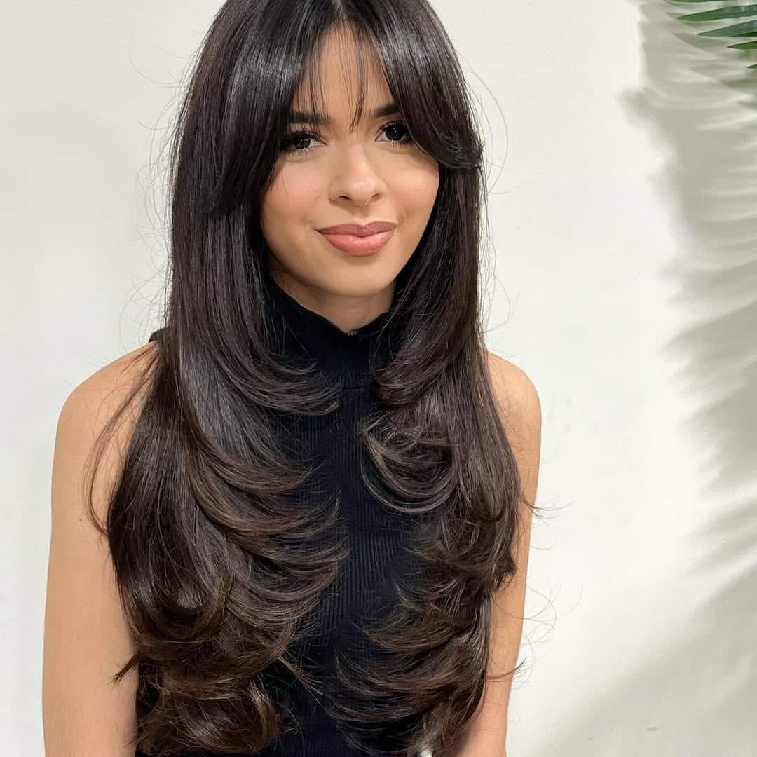 15. Long Feathered Layers with Wispy Curtain Bangs