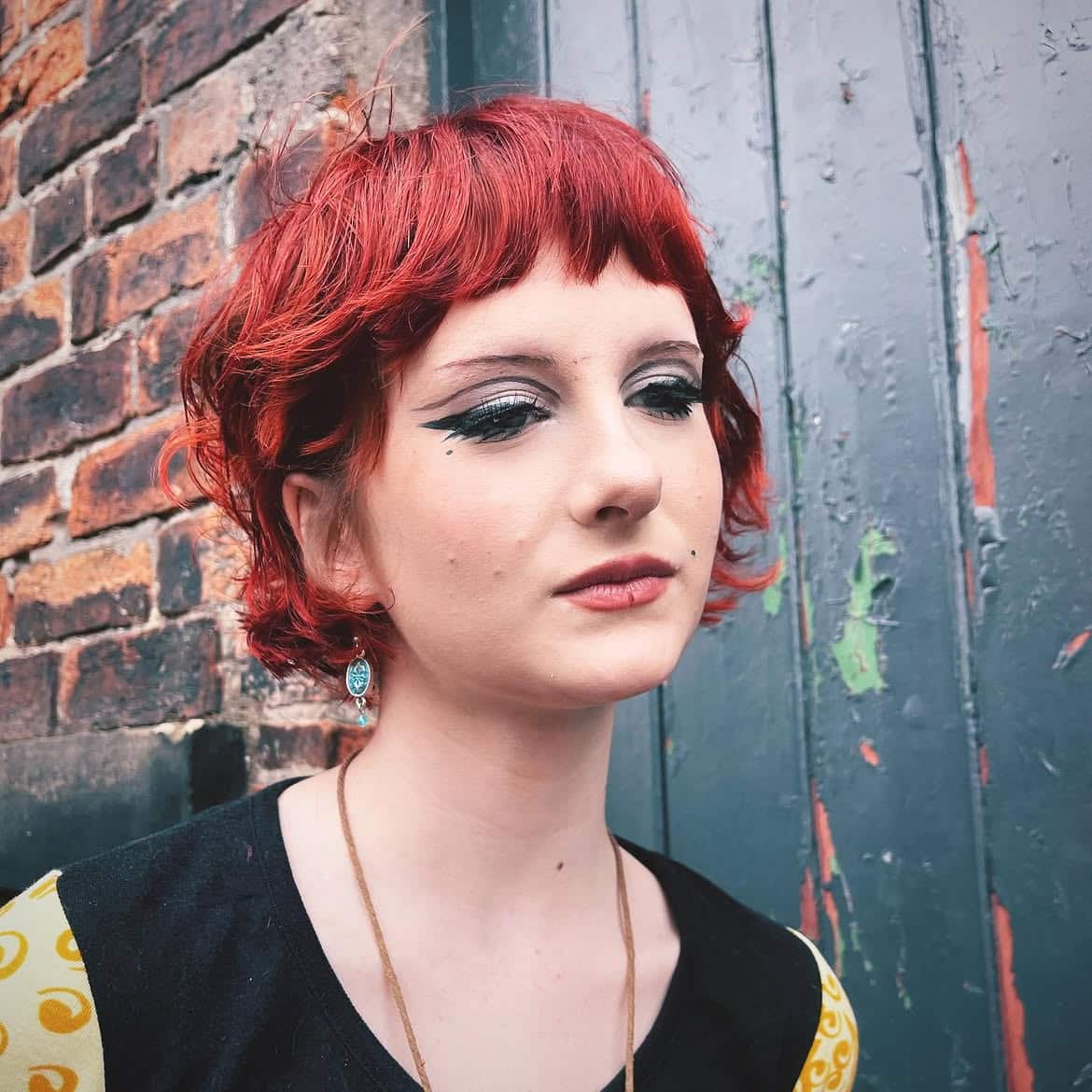 5. Shaggy Fire-Red Curly Bob with Short Bangs