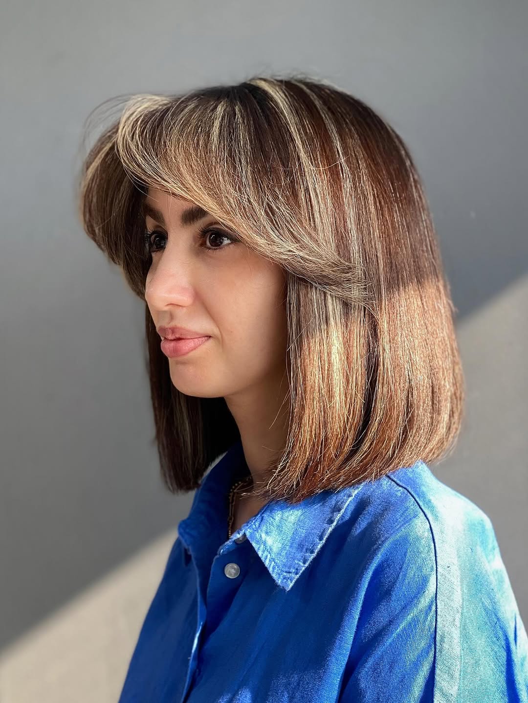 2. Sleek Bob with Voluminous Side-Swept Bangs