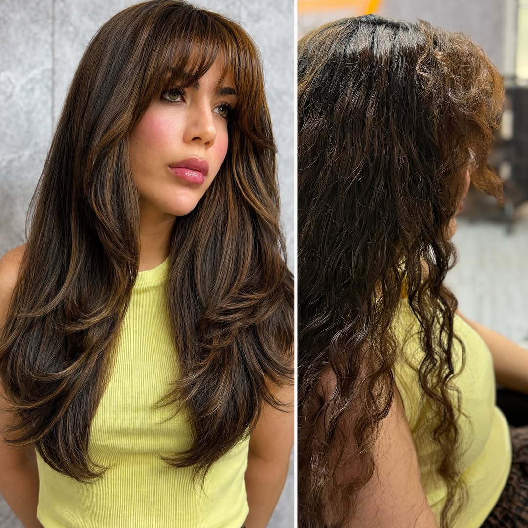 2. Sleek Layered Cut with Curtain Bangs