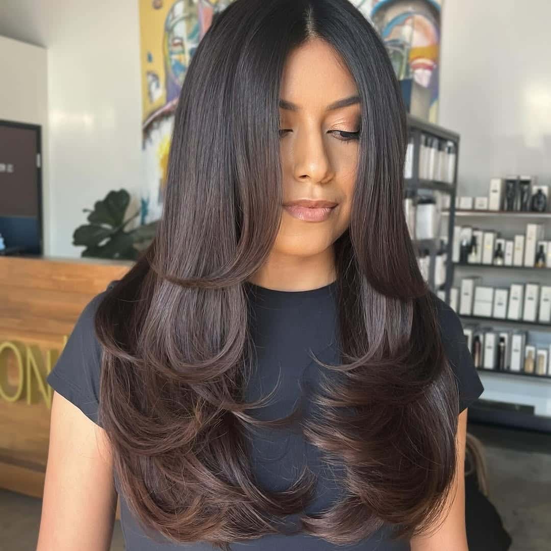21. Sleek Layers with Face-Framing Curtain Bangs