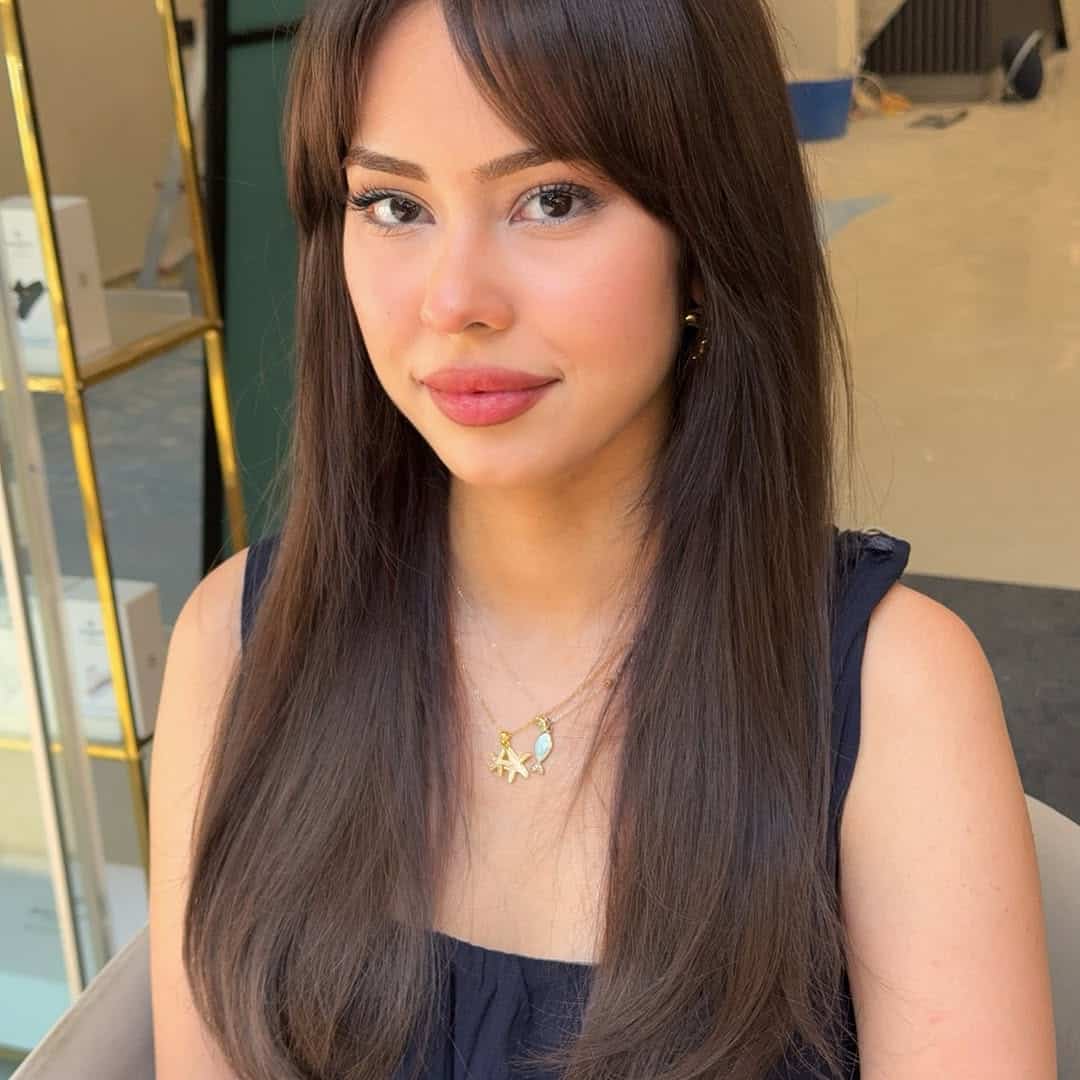 30. Soft Curtain Bangs with Sleek Layers