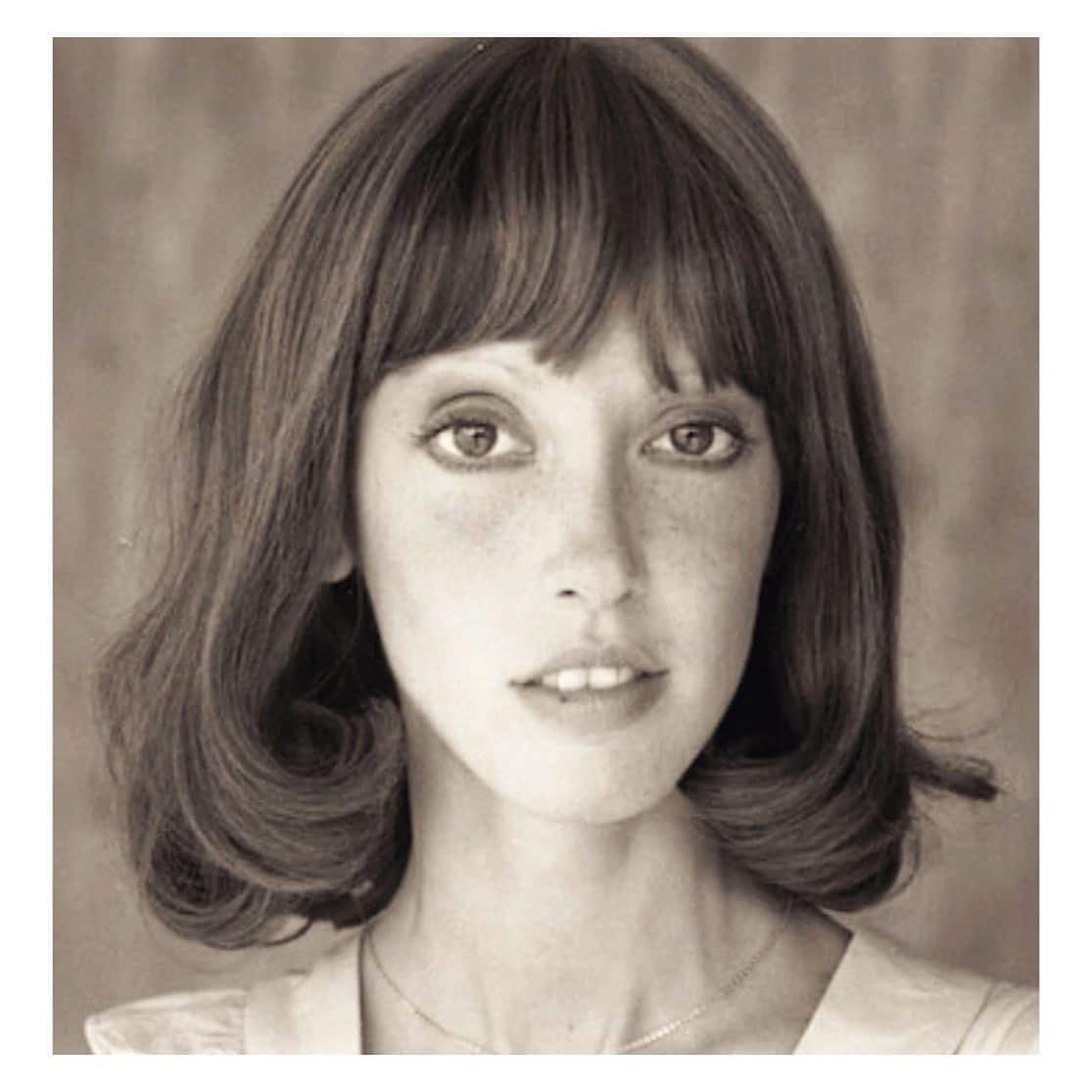 5. Soft Flicked Bob with Full Bangs