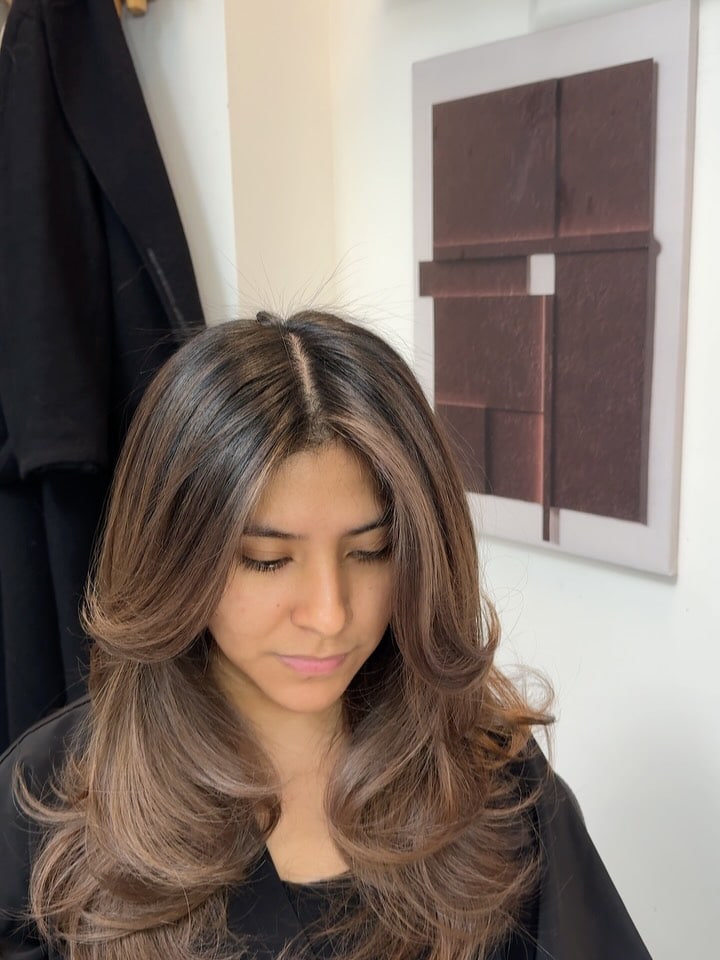 5. Soft Layers with Curtain Bangs