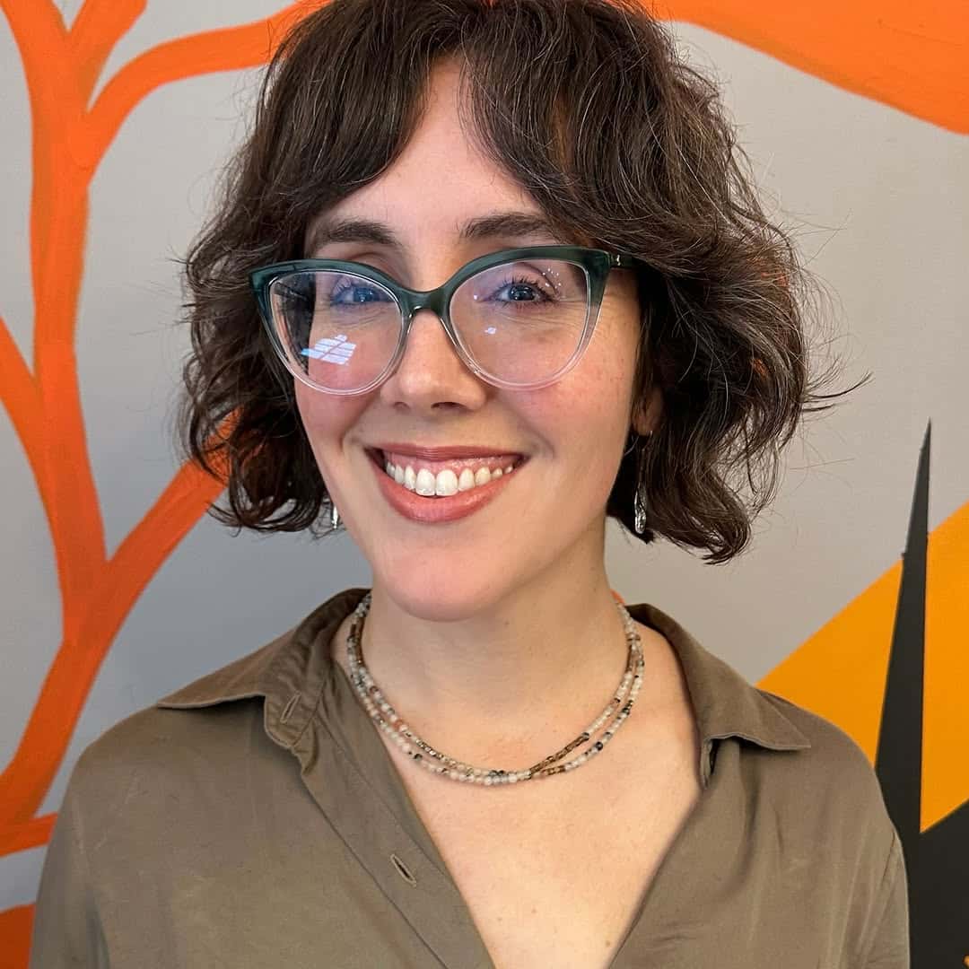 2. Tousled Curly Bob with Subtle Bangs