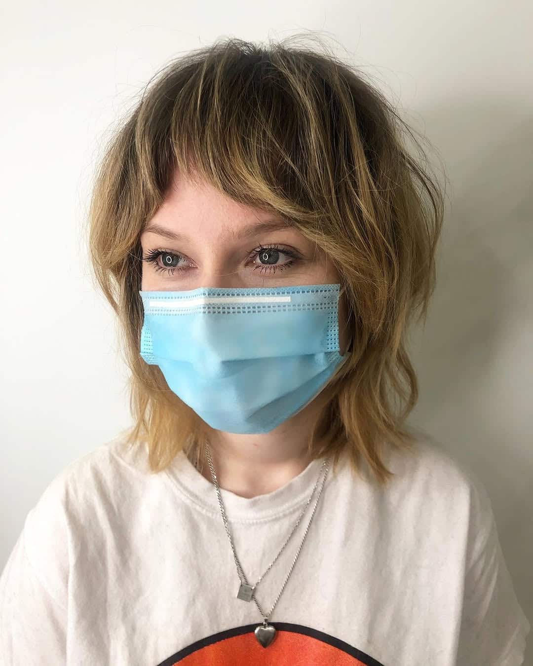 4. Tousled Shaggy Layers with Short Wispy Bangs