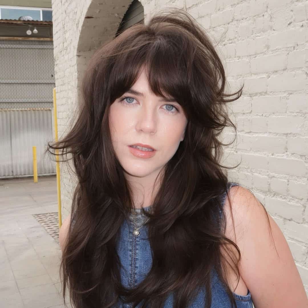 3. Voluminous Layers with Curtain Bangs