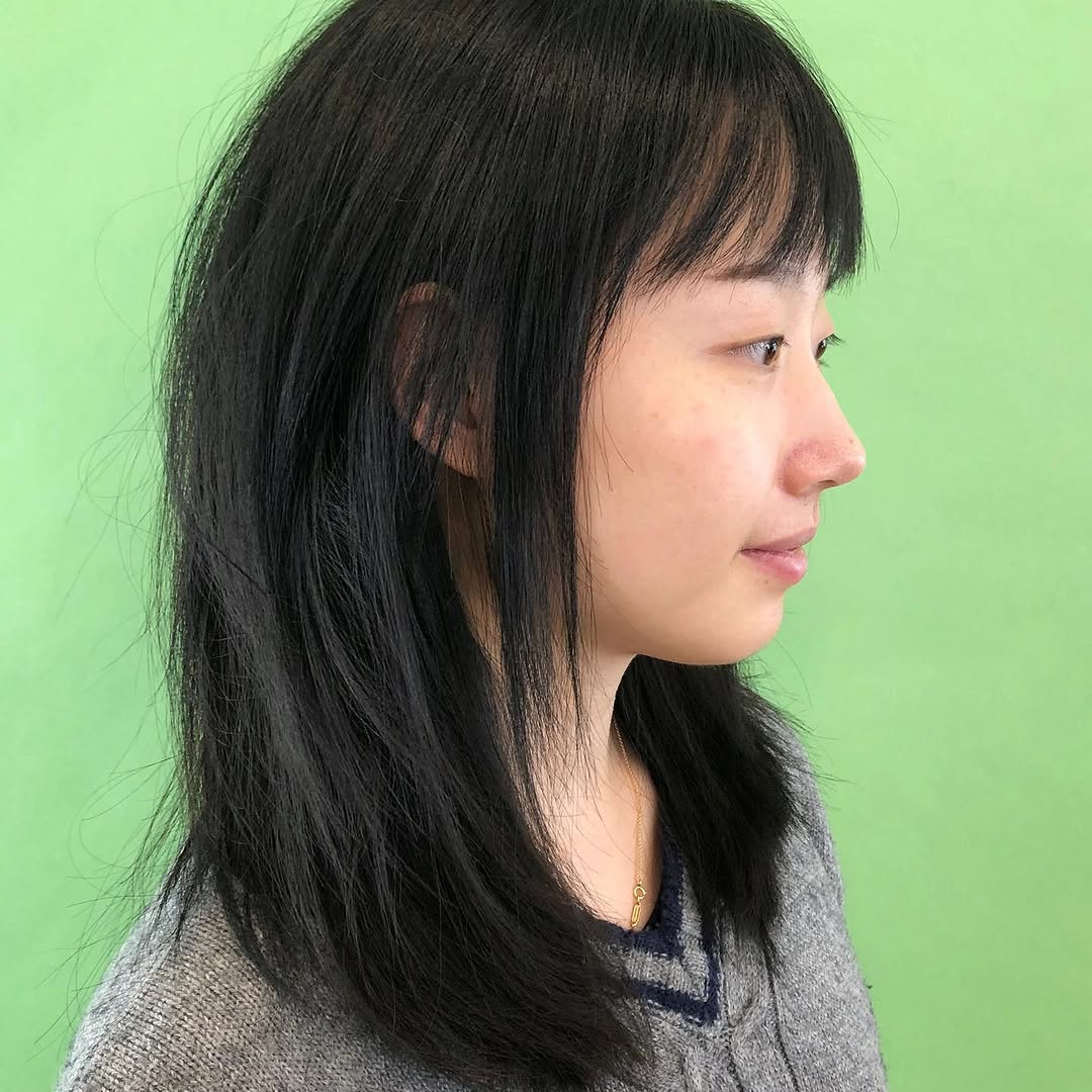 7. Wispy Layers with Feathered Bangs
